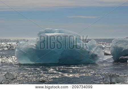 Ice And Snow Floe In A Lagoon's Waters In Iceland