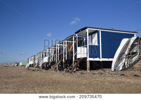 Beach huts and boats on Thorpe Bay beach near Southend Essex England
