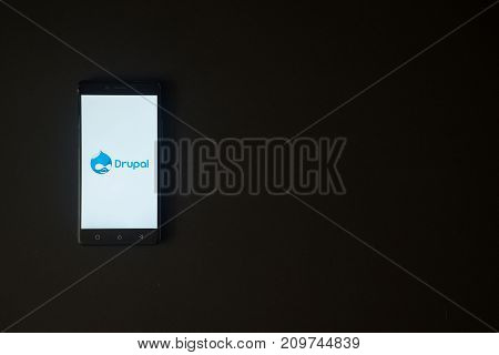 Los Angeles, USA, october 19, 2017: Drupal logo on smartphone screen on black background.