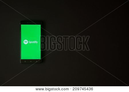 Los Angeles, USA, october 19, 2017: Spotify logo on smartphone screen on black background.