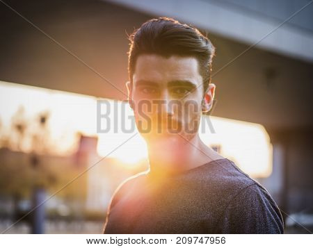 Attractive young bearded man portrait in urban environment