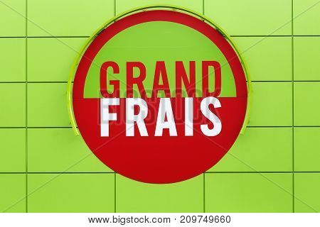 Ferney, France - October 1, 2017: Grand Frais supermarket logo on a wall. Grand Frais is a French supermarket brand, specializing in fresh produce and in the world's grocery store