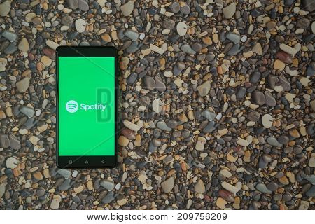 Los Angeles, USA, october 18, 2017: Spotify logo on smartphone on background of small stones