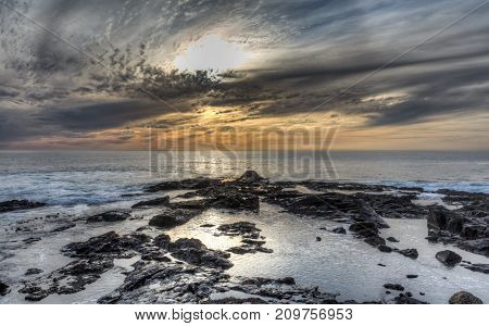 Silver and gold seascape sunset taken at Greenpoint in Cape Town, South Africa