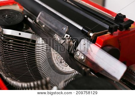 Cool vintage red typewriter on the table. Type writer maschine and mechanisms
