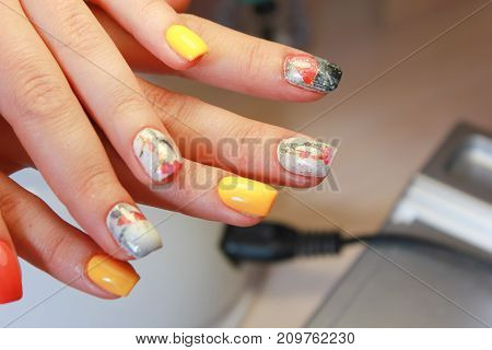Perfect manicure and natural nails. Attractive modern nail art design. Gel polish applied. autumn drawing closeup