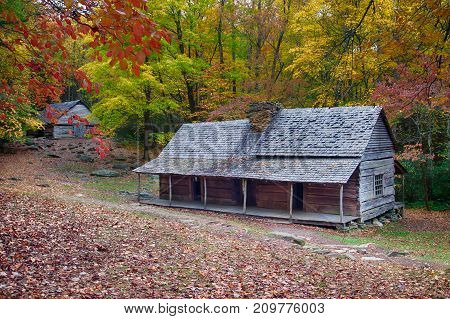 Mountain log cabin homestead with colorful fall foliage