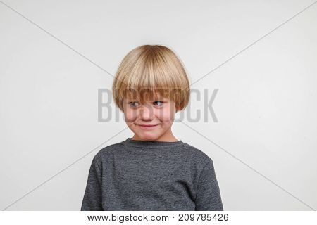 Cool horisontal portrait of handsome happy child, photo on grey background