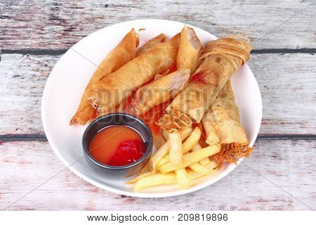 Deep Fried Spring Roll,and Frence Fries Sreved With Tomato Souce And Chili Sauce.