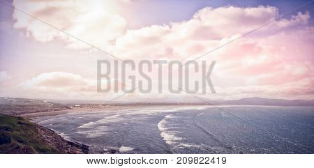 Iidyllic view of beach against cloudy sky