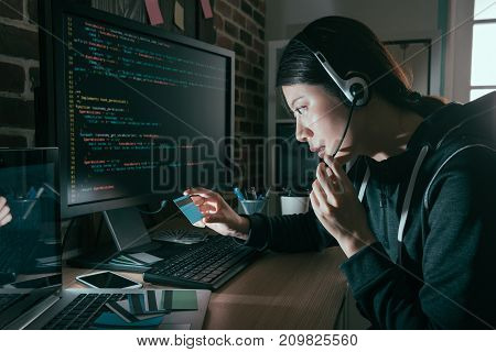 Hacker Wearing Headset And Holding Credit Card