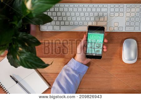 Digital composite 3D image of online education interface on screen against cropped image of hand holding mobile phone