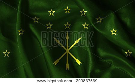 Realistic flag of Adygea on the wavy surface of fabric. This flag can be used in design.