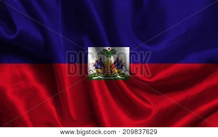 Realistic flag of Haiti on the wavy surface of fabric. This flag can be used in design.