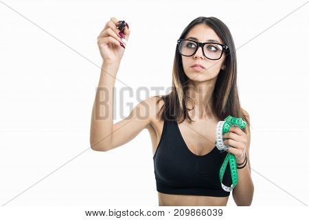 Fitt Girl Holding Measuring Tape And Writing