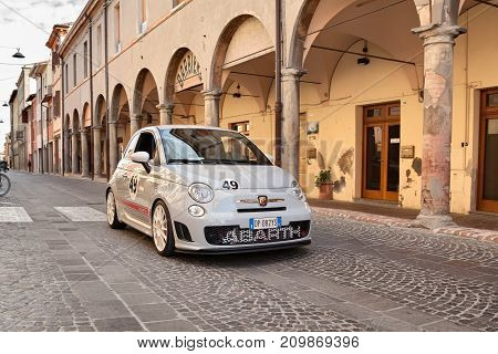 MELDOLA, FC, ITALY - OCTOBER 10: driver and passenger on a small Italian sports car Fiat 500 Abarth esseesse in car rally 