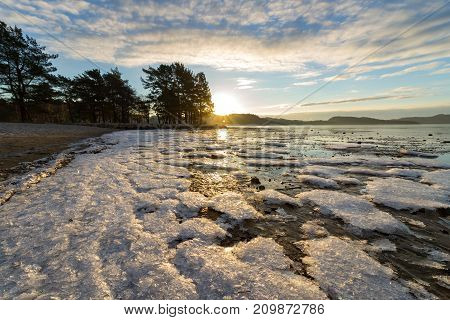 Ice crystals at the beach in winter, sun and reflections of sun in the ice, Hamresanden Norway
