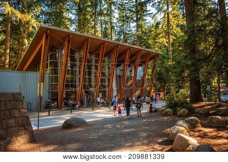 LYNN CANYON PARK, CANADA - JULY 3, 2017 : Tourists and visitors in and around the Lynn Canyon Cafe situated in the Lynn Canyon Park near Vancouver.