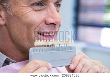 Close up of man holding medical equipment at dental clinic