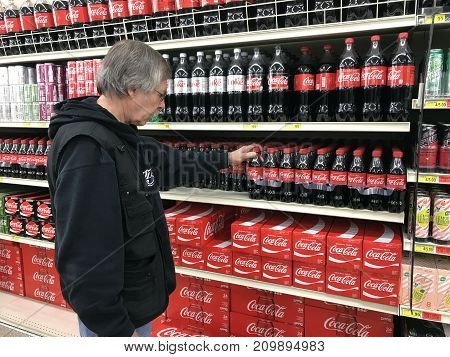 Altoona Wisconsin October 19 2017 Senior man shopping for soda in a modern Grocery store