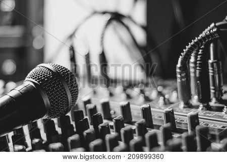 the microphone rests on an audio mixer