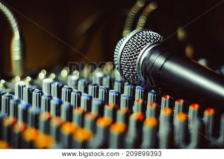 the microphone rests on an audio mixer