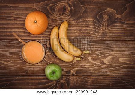 Orange Juice In Glass And Fresh Fruits On Wooden Background