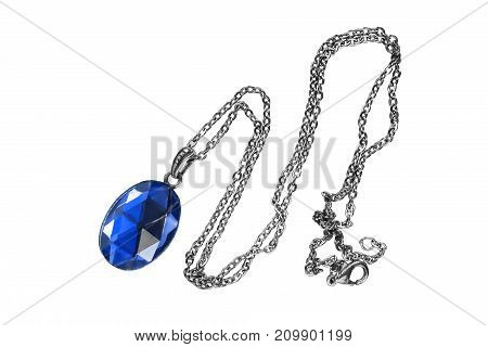 Blue sapphire faceted pendant on silver chain isolated over white