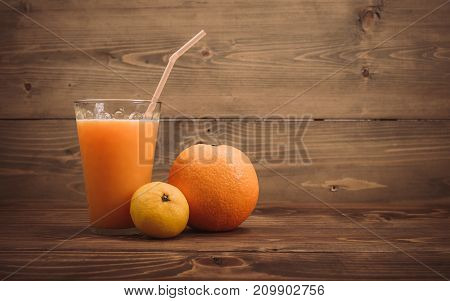 Orange Juice In Glass And Fresh Fruits On Wooden Background