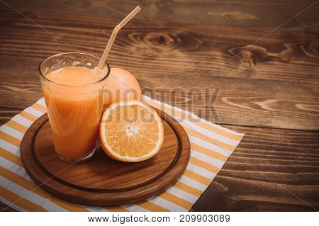 Orange Juice In Glass And Fresh Fruits On Wooden Background