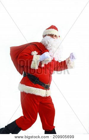 Santa Claus running with the bag of the presents.