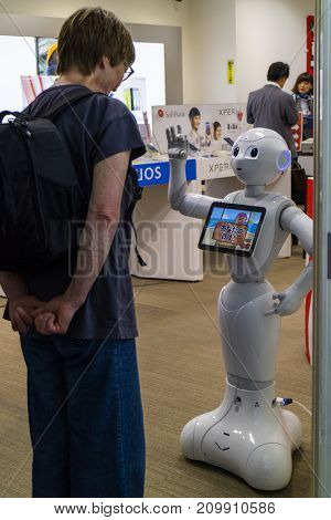 Hiroshima,Japan -  May 23, 2017: Woman communicates with a robot of the Softbank telecommunications store in the Hondori Arcade of Hiroshima 