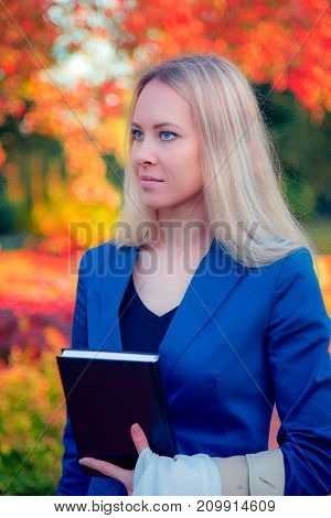 Autumn portrait of a beautiful happy woman outdoors