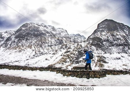Edinburgh Scotland - March 4 2010: Sportsman with backpack trekking through the wilderness mountains of Gencoe