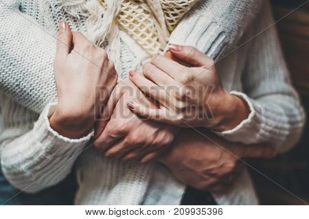 her husband gently hugs her girlfriend tenderly