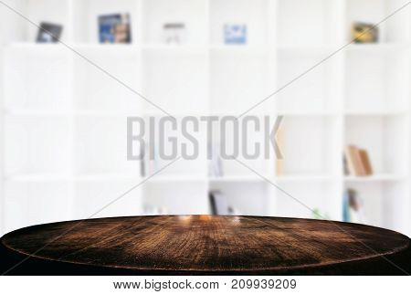 Empty wooden table and blur background of abstract in front of modern library or knowledge source can be used Mock up for display of product or for montage.