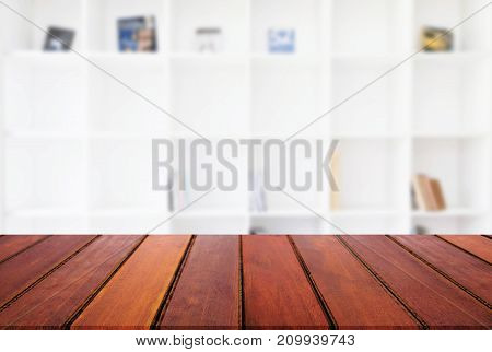 Empty wooden table and blur background of abstract in front of modern library or knowledge source can be used Mock up for display of product or for montage.