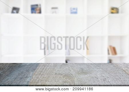 Empty wooden table and blur background of abstract in front of modern library or knowledge source can be used Mock up for display of product or for montage.