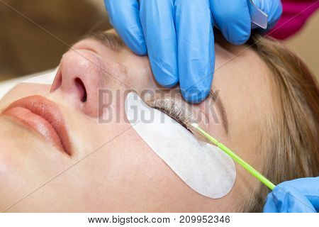 Woman on the procedure for eyelash extensions, eyelashes lamination