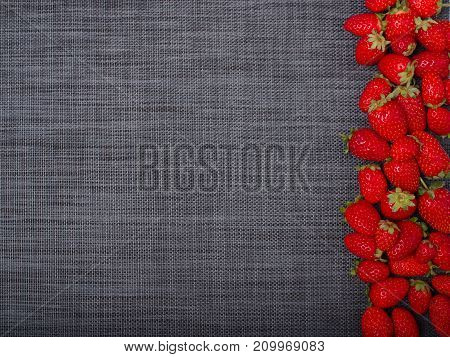 Fresh ripe fruits. Sweety red strawberries summer fruits on a gray background. Copy space. Close-up of strawberry. Food concept.