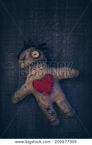 Voodoo doll with pins stuck into it