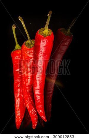 Closeup Hot Red Hili Peppers On Black Glass Background