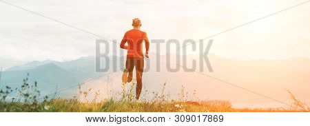 Man Dressed In Red Long Sleeve Shirt Runs By The Road With Mountain Background Wide Angle Shoot.