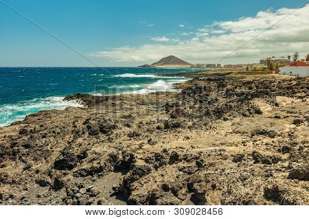 Beautiful Coastal View Near El Medano. Montana Roja - Red Rock In The Background. Shining Blue Sky A