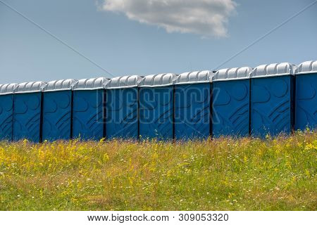 Blue Plastic Toilets In Row At Local Horse Race  In Moacsa, Covasna.