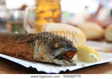 Fresh Mackerel On Stick At Barbecue Party. Germany