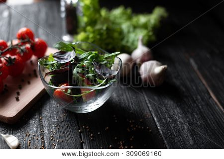 Lined Greek Salad With Tomatoes Arugula With Basil And Fett Olives In A Glass Plate