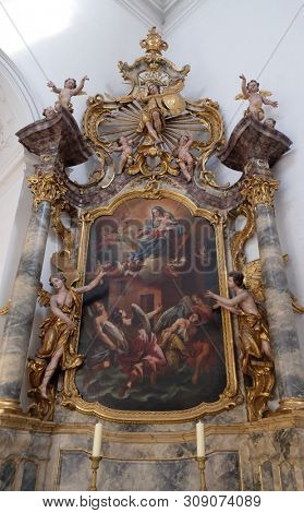 WURZBURG, GERMANY - JULY O4, 2018: Madonna with child Jesus, St. Michael altar in the Neumunster Collegiate Church in Wurzburg, Germany