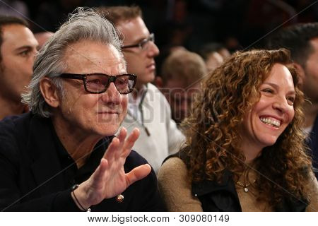 NEW YORK - FEB 10: Harvey Keitel (L) and wife Daphna Kastner attend the game between the New York Knicks and the Los Angeles Clippers at Madison Square Garden on February 10, 2013 in New York City.