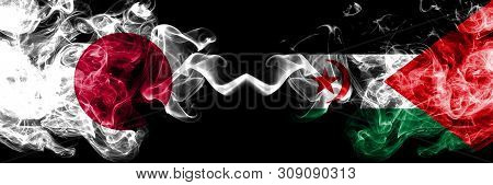 Japan Vs Sahrawi Smoky Mystic Flags Placed Side By Side. Thick Colored Silky Smokes Combination Of S